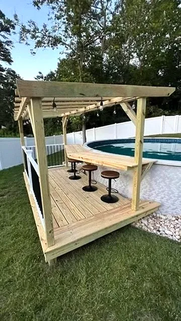 Completed timber pergola beside a pool from a past project, view 1